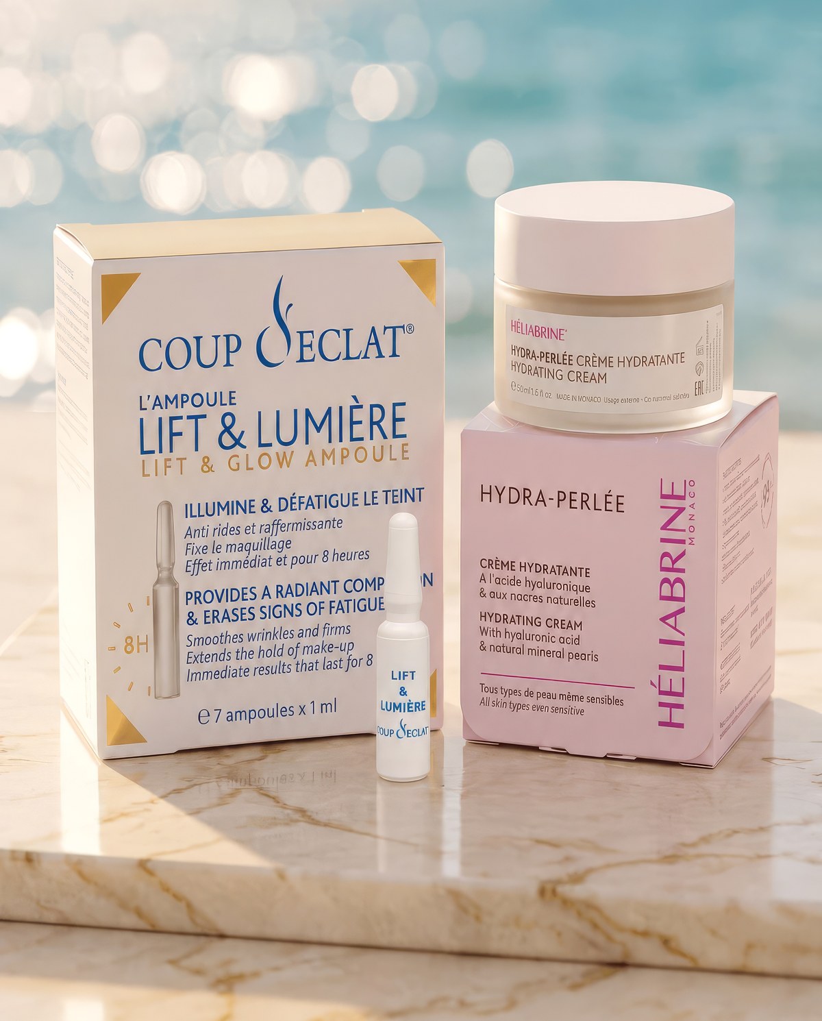 Coup d'Eclat Lift and Glow ampoules and Heliabrine Hydra-Perly cream on marble by the sea